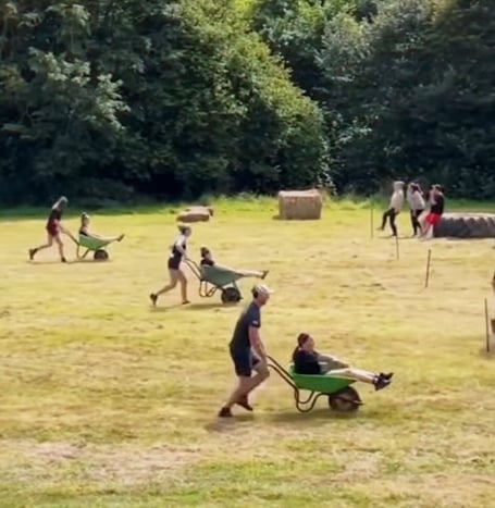 Participants in the wheelbarrow race at Ashcombe Olympics