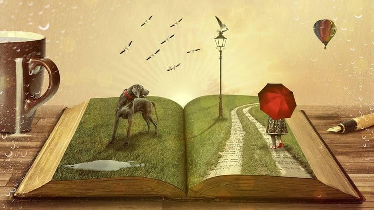 Open book with imagery of grass, a dog, a lampost, and a girl walking with a red umbrella.