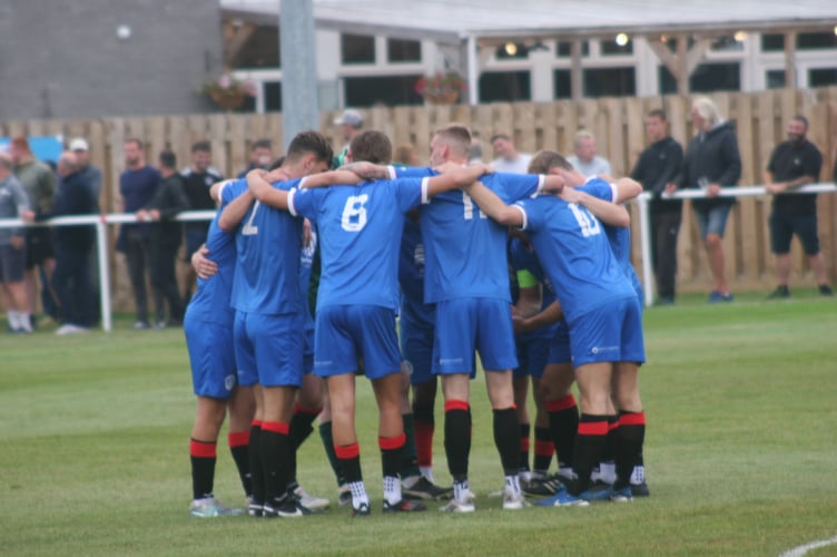 Newton Abbot Spurs huddle vs Bovey Tracey AFC