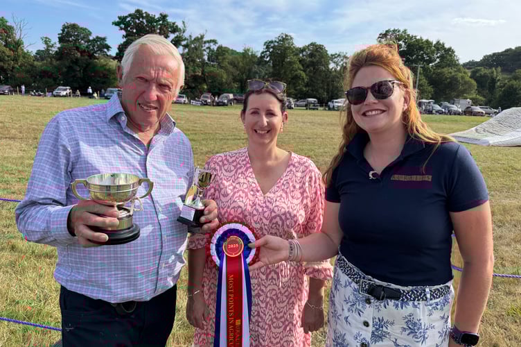 John Jordan gained the Most Points at Chagford Show, pictured receiving a trophy from Show Secretary Tiggy Fuller, centre and sponsor Rosie Ware from Ruralis Insurance.  AQ 1143
