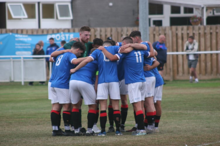 Newton Abbot Spurs huddle vs Stoke Gabriel