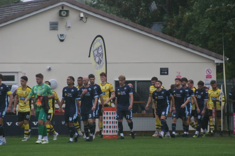 Buckland Athletic and Bradford Town players walking out