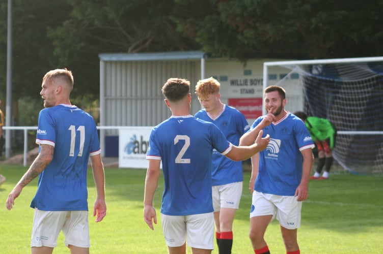 Toby Pullman celebrates his second of the afternoon with Spurs teammates