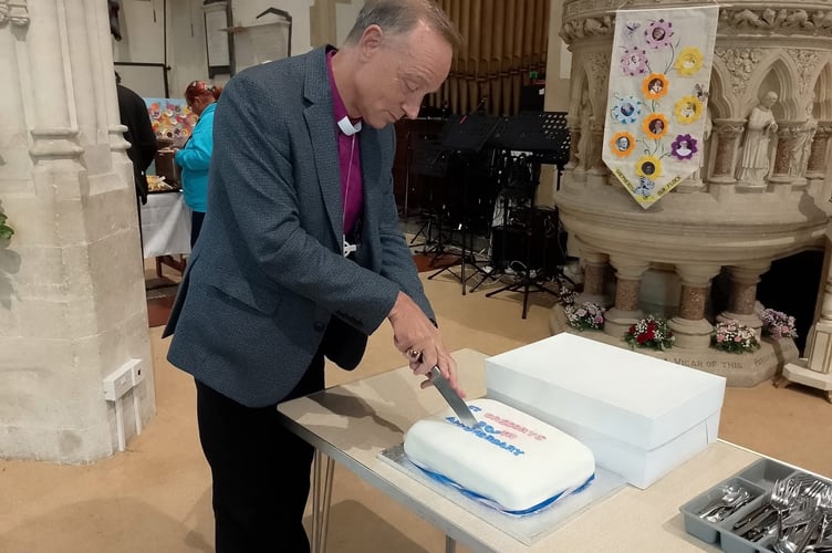 Bishop Mike Harrison cuts the celebration cake. Photo Noreen Goodchild 