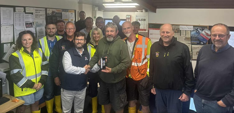 Charlie Woolnough receives his long-service medal in recognition of 30 years of dedication and commitment to RNLI Teignmouth