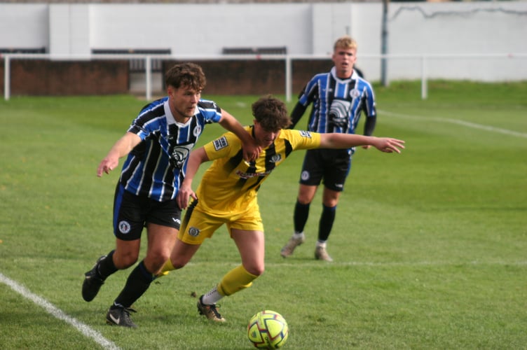 Newton Abbot Spurs fullback Calum Fyfe holds off his man