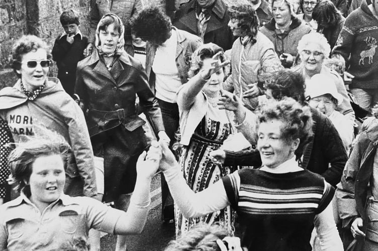 The Furry Dance winds its way through Moretonhampstead during the town's carnival from August 1977