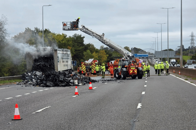 An articulated lorry well alight with smoke and flames 