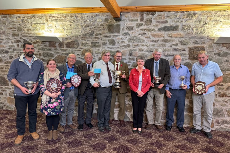 Devon County Ploughing Association 2025 winners and the association officers with, centre, Devon Champion Peter Stone, fifth left.  AQ 7143
