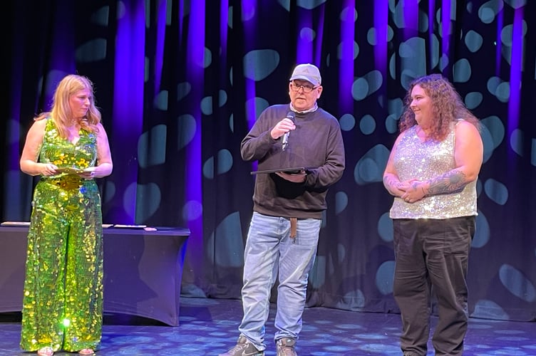 Chloe Myers from Teignbridge CVS, who organised the event, congratulates Together Devon on the surprise Stars of Teignbridge award in recognition of its vibrant and compassionate volunteers who are deeply rooted in the community.