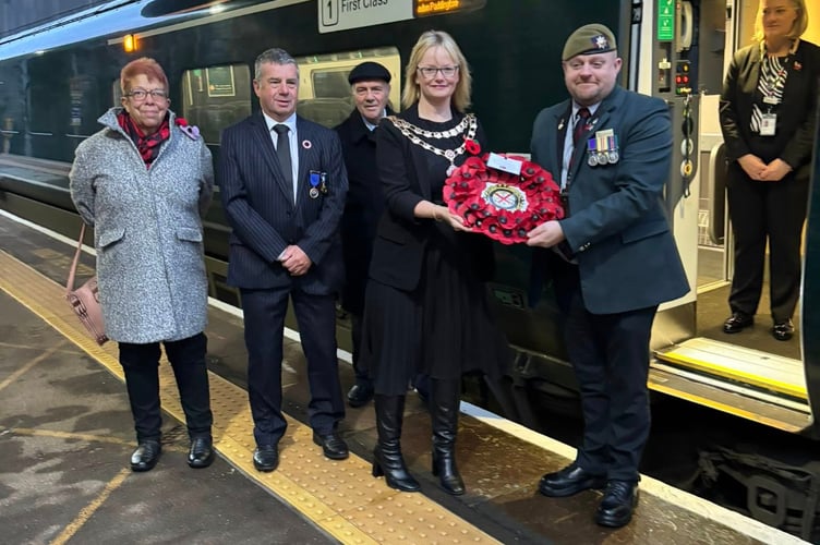 Councillors Vanda Rudge and Pete Williams with Teignmouth Mayor councillor Cate Williams present a wreath for the GWR Poppies to Paddington train