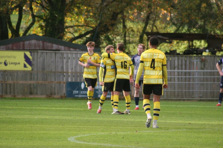 Isaac McCue (left) heads to celebrate with goalscorer Ben Carter