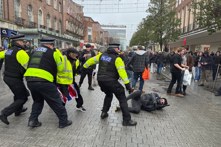 A protester on the ground near Bedford Square before he was placed in handcuffs. AQ 8789