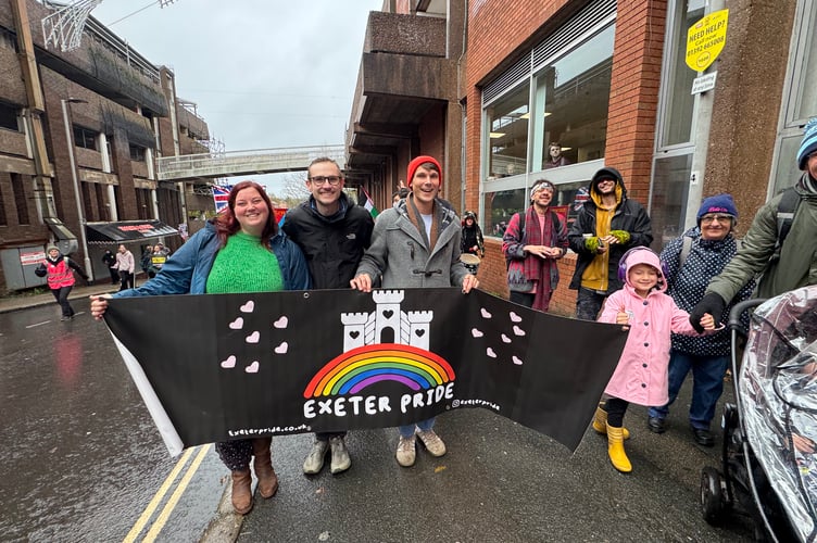 Exeter Pride members walking in the Exeter is for Everyone march. AQ 8621
