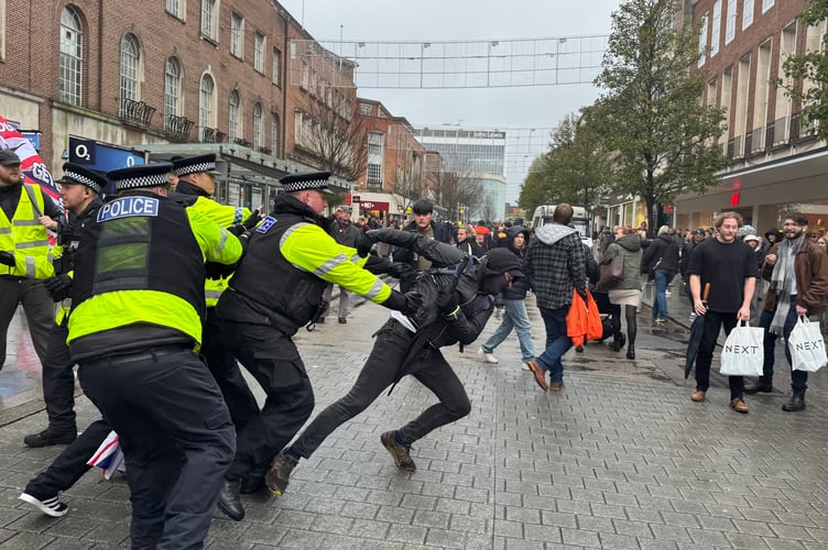Police attempt to stop a protester before he was handcuffed. AQ 8788