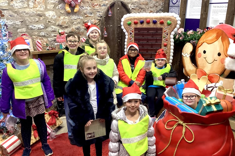 Pupils from Newton Abbot's All Saints Marsh C of E Academy visit Santa's Grotto in St Leaonard's Tower after hiding cards and decorations around the town