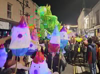 Children proudly carry Christmas lanterns in town parade 