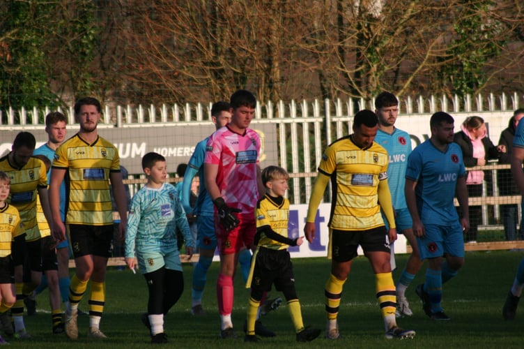 Myles James leads Buckland out against Barnstaple.