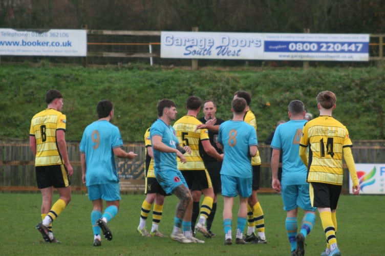 Buckland and Barnstaple players pushing and shoving