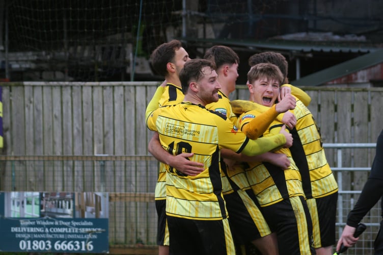Buckland players celebrate Ryan Bush's opener against Barnstaple