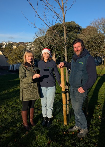 Teignmouth mayor councillor Cate Williams receives the Tulip Tree plaque from Teign Trees' Charlotte Steel and Tristan Doble.
