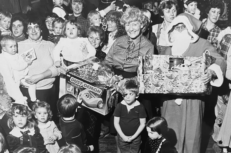 Father Christmas pays a visit to Kingskerswell Toddler Group in December 1984