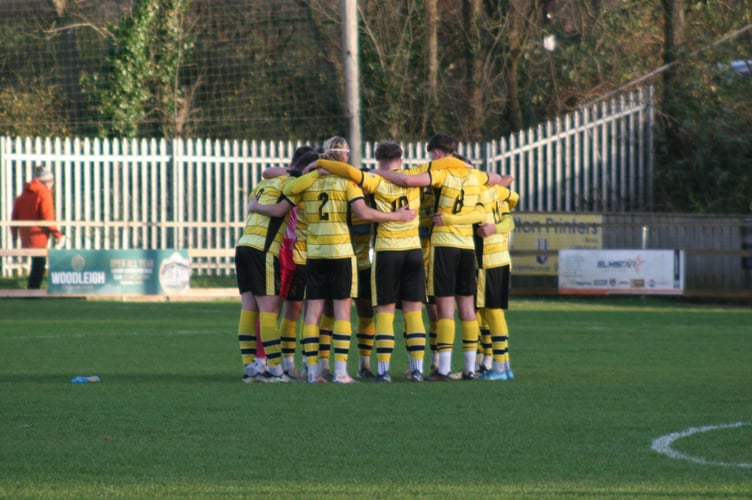 Buckland Ath huddle before kickoff against Barnstaple