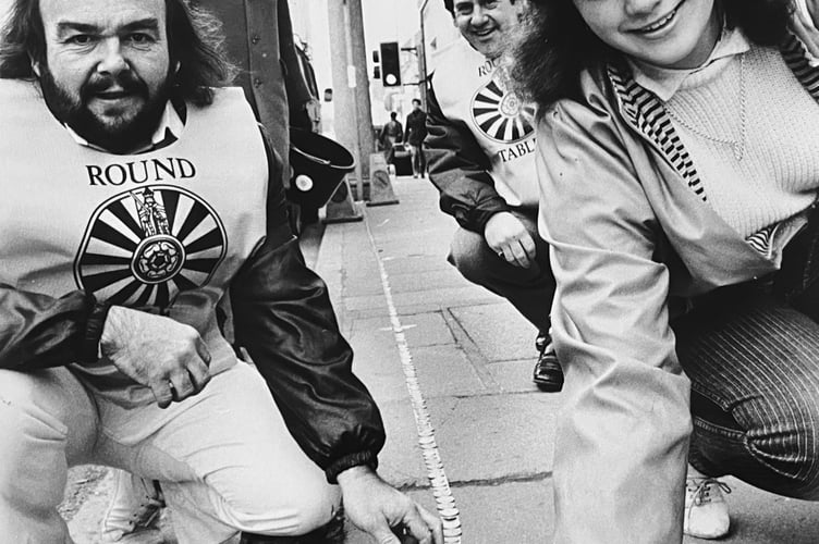 Newton Abbot Round Table members laying a silver trail in the streets of the town in November 1985