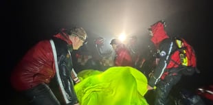 Rescuers battle wind and rain to help injured walker