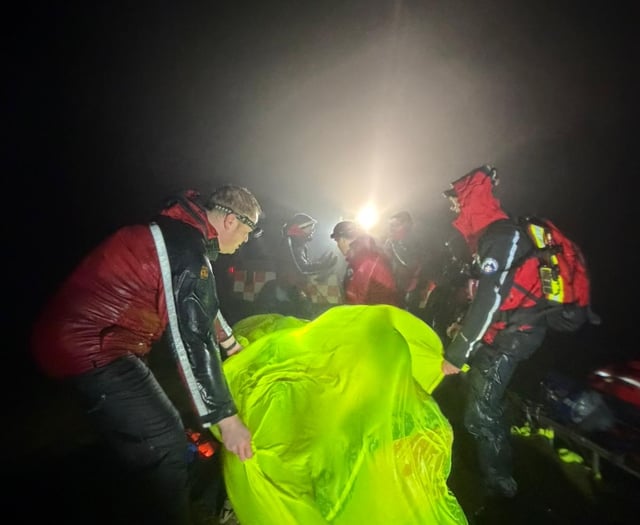 Rescuers battle wind and rain to help injured walker