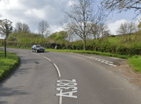 Fallen tree blocks moorland road 
