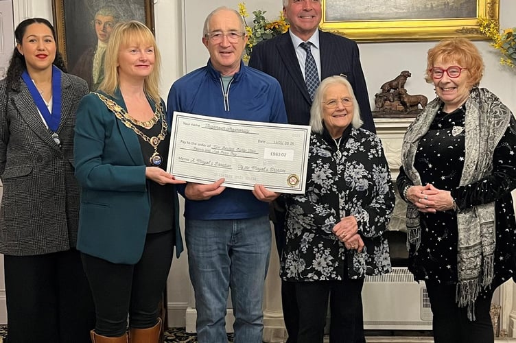 L-R Teignmouth mayor councillor Cate Williams hands over a cheque for £983.02 to Teignmouth Shopmobility.