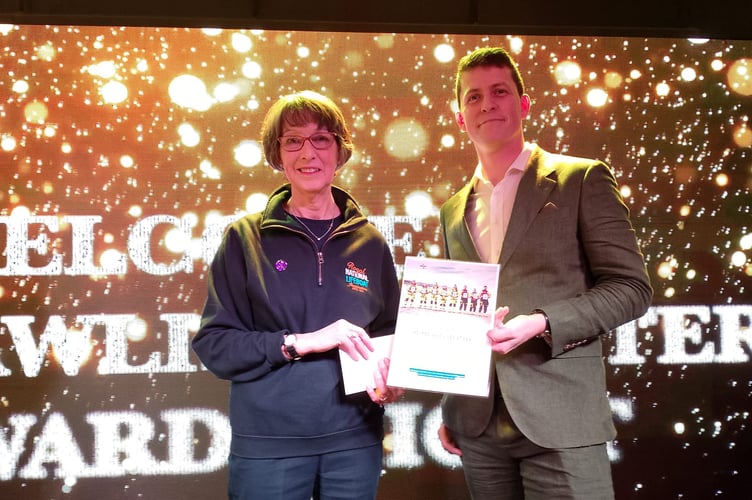 Teignmouth RNLI fundraising chair Wendy Richards Wood accepts a cheque for £500 from Dawlish Coasters chair Alex Sykes.