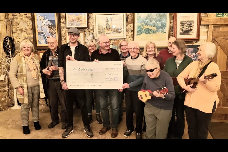 Members of Newton Abbot Ukelele Club presented a cheque for £200 to the Cwtch Hub.