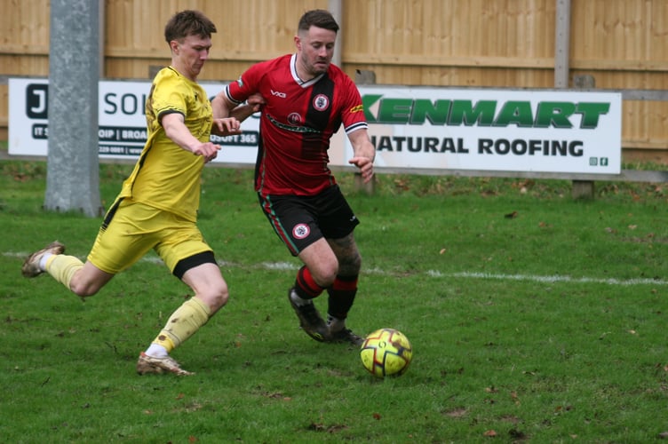 Bovey's Josh Webber looks to beat the Bridport fullback