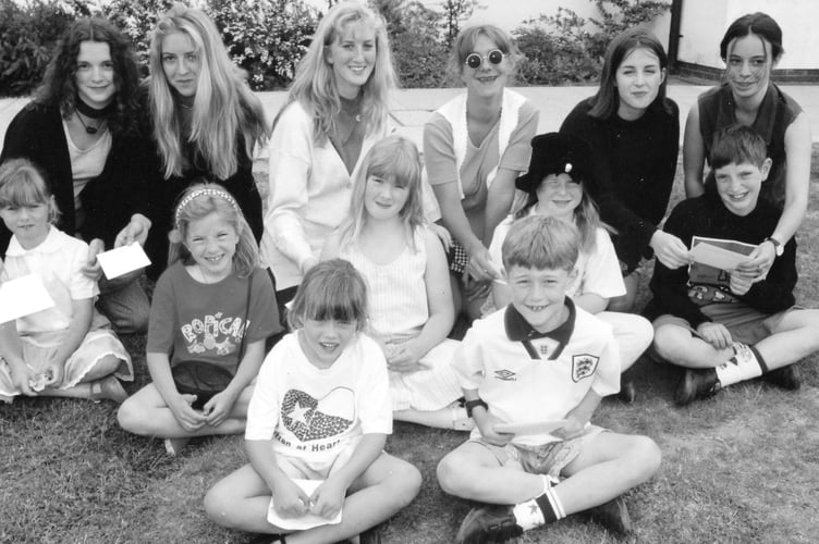 Winners of the colouring competition at Gatehouse School Fete in Dawlish with members of the singing group Ala-Lahkai who sang and opened the event in June 1991