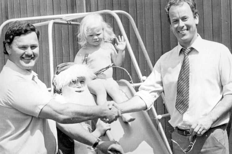 Presentation of a climbing frame at Doddiscombleigh Fete in June 1984. From left: Mr P Baxter, Miss Rosie Travell and Miss Faith Travell and quarry manager Mr P Hughes