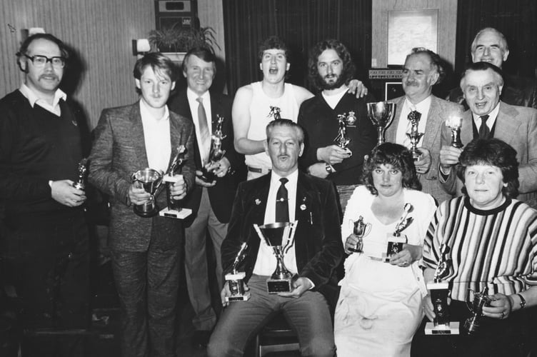 Indoor Sports winners pose for the cameras at Teignmouth's Royal British Legion Club in April 1986.
From left (rear) Trevor Wall, Royston Couch, Ton Beazer, Allen Wainwright, Martin Taylor, Ron Bailey, Ray Davey and Hardy Etheridge. Front: John Couch, Melanie Taylor and Mary Couch