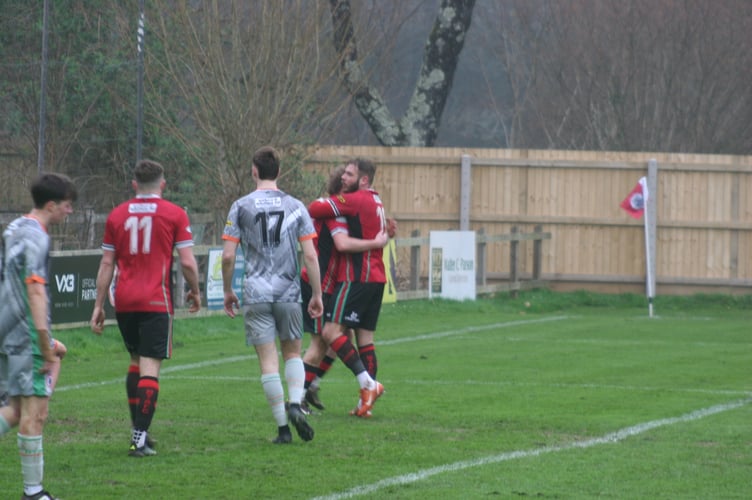 Stuart Bowker embraces Bovey goalscorer Levi Landricombe