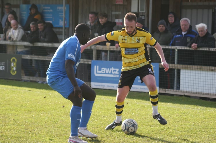 Buckland's Luke Forward looks to beat his man