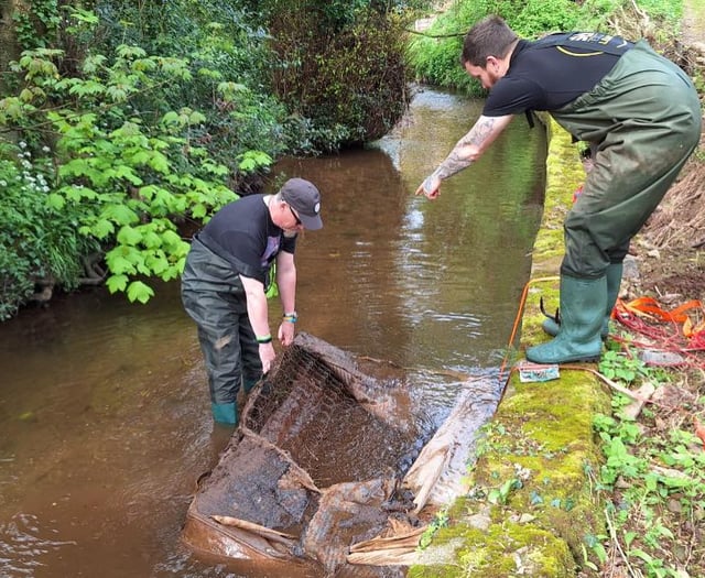 Volunteers remove mattress dumped in waterway