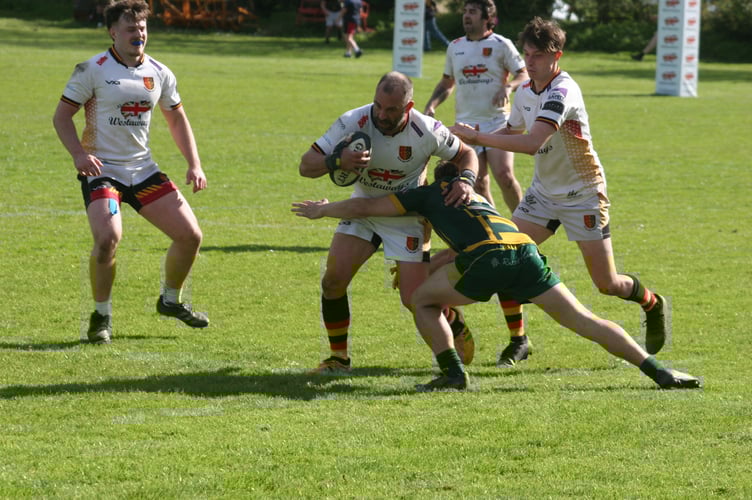 Newton Abbot's Joe Frost looks to power through the tackle.
