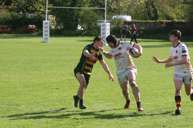 Jed Griffin looks to fend off the Plymstock defender
