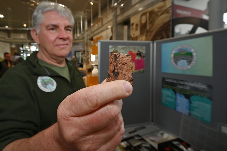 Teignbridge Archaeological Society archaeology fair at Newton Abbot Town Hall. TS member Clive Hammett and a Roman coin die stamp found near the Newton Abbot to Totnes Road