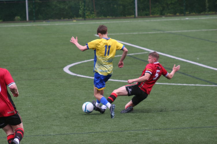 Bovey goalscorer Ollie Cifford-Bourne with one of a few perfect sliding tackles