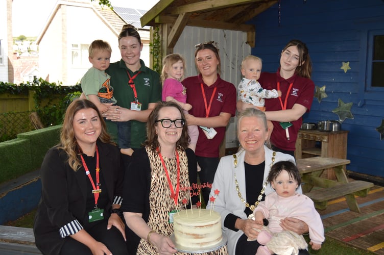 Staff at Puffins nursery in Dawlish celebrate first year of operation with Mayor of Dawlish Cllr Anne Heywood. Photo Puffins