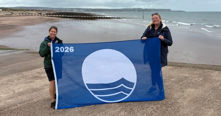 Teignbridge Council officers on Dawlish Warren beach with its Blue Flag