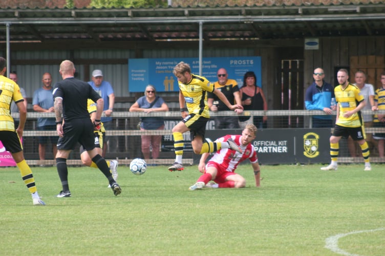 Bucks skipper Ben Carter skips away from a sliding tackle
