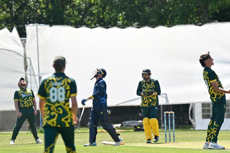 Devon Cricket League Division B. Bovey 2nds versus Plymstock 1st. Bovey bowler Jack Ainsley delighted that Ben Steer has after caught out Josh Sumner off his delivery, although Sumner does not share his delight