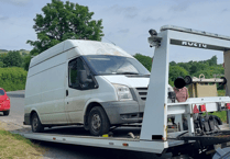 Recovery truck leaves scene with two seized cars